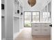 Bright walk-in closet with custom cabinetry and island at 10771 Holliday Farms Blvd, Zionsville, IN 46077