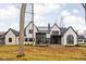 Modern farmhouse with large windows and a screened-in porch at 10771 Holliday Farms Blvd, Zionsville, IN 46077