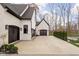 Two-car garage with dark brown doors and white brick exterior at 10771 Holliday Farms Blvd, Zionsville, IN 46077