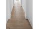 Long hallway with light hardwood floors and white walls at 10771 Holliday Farms Blvd, Zionsville, IN 46077