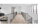 Modern hallway with hardwood floors and metal railing at 10771 Holliday Farms Blvd, Zionsville, IN 46077