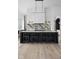Modern kitchen with marble countertops, black island, and a wine storage feature at 10771 Holliday Farms Blvd, Zionsville, IN 46077