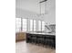 Open concept kitchen with an island, marble countertops and modern light fixture at 10771 Holliday Farms Blvd, Zionsville, IN 46077