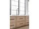 Modern kitchen sink and cabinetry with marble countertops and large windows at 10771 Holliday Farms Blvd, Zionsville, IN 46077