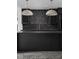 Dark kitchen island with unique backsplash and lighting at 10771 Holliday Farms Blvd, Zionsville, IN 46077