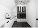 Laundry room with hexagon tile floor, white cabinets, and patterned ceiling at 10771 Holliday Farms Blvd, Zionsville, IN 46077