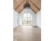 Bright living room with vaulted ceiling, hardwood floors, and large arched window at 10771 Holliday Farms Blvd, Zionsville, IN 46077