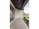 Covered side patio with grey stone tile and white brick walls at 10771 Holliday Farms Blvd, Zionsville, IN 46077
