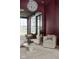 Cozy sitting room with a maroon accent wall and comfortable seating at 10771 Holliday Farms Blvd, Zionsville, IN 46077