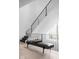 Modern staircase with black metal railing and leather bench at 10771 Holliday Farms Blvd, Zionsville, IN 46077