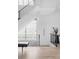 Modern staircase with black metal railing and leather bench at 10771 Holliday Farms Blvd, Zionsville, IN 46077