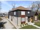 Modern two-story home with gray and wood siding, landscaping, and a walkway at 1514 E 12Th St, Indianapolis, IN 46201