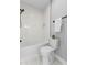 Clean bathroom with a shower/tub combo, toilet and white tile at 1514 E 12Th St, Indianapolis, IN 46201