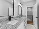 Modern bathroom with double vanity, granite countertop, and black accents at 1514 E 12Th St, Indianapolis, IN 46201