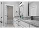 Bathroom with double vanity, granite countertop, and black accents at 1514 E 12Th St, Indianapolis, IN 46201
