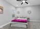 Cozy bedroom with gray walls, queen bed, and two sunburst mirrors at 1514 E 12Th St, Indianapolis, IN 46201