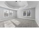 Spacious bedroom with tray ceiling, plush carpeting, and ample natural light at 1514 E 12Th St, Indianapolis, IN 46201