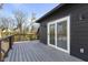 Modern deck with gray wood planks, sliding glass door access, and metal railing at 1514 E 12Th St, Indianapolis, IN 46201