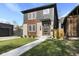 Modern two-story home with gray and wood siding, landscaping, and a walkway at 1514 E 12Th St, Indianapolis, IN 46201