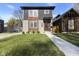 Modern two-story home with gray and wood siding, landscaping, and a walkway at 1514 E 12Th St, Indianapolis, IN 46201