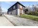 Side view of a modern two-story home with gray and wood siding at 1514 E 12Th St, Indianapolis, IN 46201