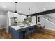 Modern kitchen with white shaker cabinets, quartz countertops, and a blue island at 1514 E 12Th St, Indianapolis, IN 46201