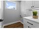 Convenient laundry room with white cabinets and quartz countertop at 1514 E 12Th St, Indianapolis, IN 46201