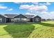 Rear view of a ranch house with a large backyard at 161 Maxim Ct, Cumberland, IN 46229
