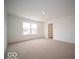 Bright bedroom featuring a window, carpet, and access to a bathroom at 259 Lar Lan Dr, Danville, IN 46122