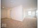 Large carpeted bedroom with access to a hallway and another room at 259 Lar Lan Dr, Danville, IN 46122