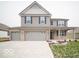 Two-story house with gray siding, brick accents, and a three-car garage at 259 Lar Lan Dr, Danville, IN 46122