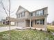 Two-story house with gray siding, brick accents, and a three-car garage at 259 Lar Lan Dr, Danville, IN 46122