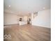 Spacious living area with hardwood floors and an open staircase at 259 Lar Lan Dr, Danville, IN 46122