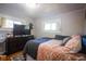 Bright bedroom featuring a full bed, dresser, and large window at 3136 E Edgewood Ave, Indianapolis, IN 46227