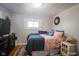 Well-lit bedroom with a full bed and dark wood dresser at 3136 E Edgewood Ave, Indianapolis, IN 46227