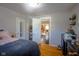Cozy bedroom with wood floors and a view of the kitchen at 3136 E Edgewood Ave, Indianapolis, IN 46227