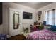 Comfortable bedroom with a full bed, a desk, and a large mirror at 3136 E Edgewood Ave, Indianapolis, IN 46227