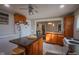 Kitchen with an island, view into dining area, and wood cabinets at 3136 E Edgewood Ave, Indianapolis, IN 46227