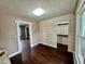 Bright bedroom with hardwood floors and wood-paneled accent wall at 5719 Hickory Rd, Indianapolis, IN 46239