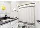 Clean bathroom with a single vanity, grey countertop and a shower/tub combo at 1014 Sterling St, Indianapolis, IN 46201