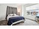 Bright bedroom with a comfortable bed, grey curtains, and a view of the neighborhood at 1014 Sterling St, Indianapolis, IN 46201