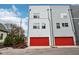 Modern townhome with attached two-car garage and gray siding at 1014 Sterling St, Indianapolis, IN 46201