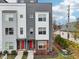 Modern three-story townhome with red front door and gray siding at 1014 Sterling St, Indianapolis, IN 46201