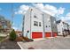 Modern three-story townhome with attached two-car garage and private driveway at 1014 Sterling St, Indianapolis, IN 46201