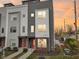 Modern three-story townhouse with welcoming front porch and landscaping at 1014 Sterling St, Indianapolis, IN 46201