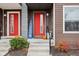 Inviting front entrance with red door, pumpkins, and a welcome sign at 1014 Sterling St, Indianapolis, IN 46201