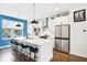 Modern kitchen with white cabinets, blue accent wall, and an island at 1014 Sterling St, Indianapolis, IN 46201