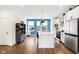 Modern kitchen with white cabinets, blue accent wall, and island with seating at 1014 Sterling St, Indianapolis, IN 46201