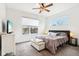 Spacious bedroom with large window, ceiling fan, and plush bedding at 1014 Sterling St, Indianapolis, IN 46201
