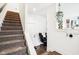 Modern staircase with carpeted steps and wood handrail at 1014 Sterling St, Indianapolis, IN 46201